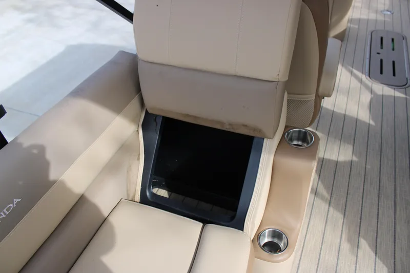 Slide: The Image of 2023 Veranda VR22RC boat interior with beige seating and cup holders. - 16