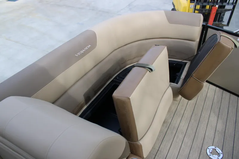 Slide: The Image of 2023 Veranda VR22RC boat seating with storage compartments, beige upholstery, and wood-style flooring. - 18