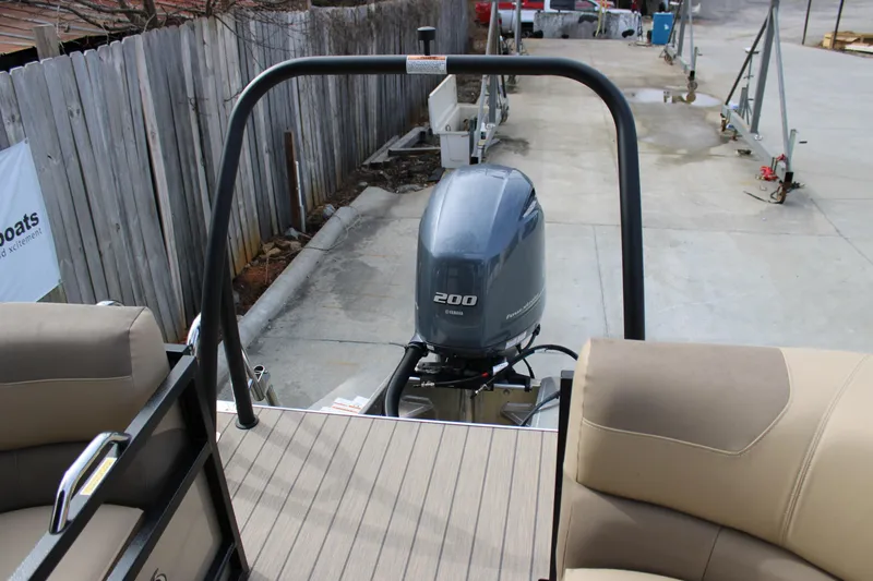 Slide: The Image of 2023 Veranda VR22RC pontoon boat with Yamaha 200 engine, docked on concrete. - 7