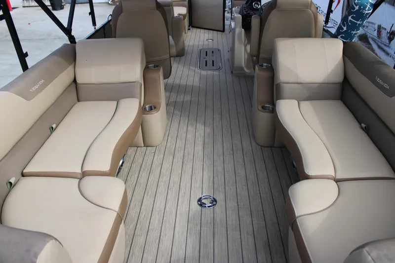 Slide: The Image of 2023 Veranda VR22RC pontoon boat interior with beige seating and wood-style flooring. - 8