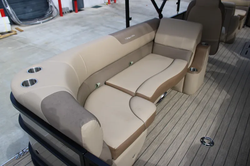 Slide: The Image of 2023 Veranda VR22RC boat interior with beige seating and cup holders. - 9