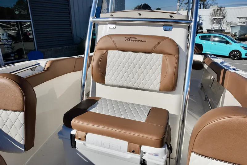 Slide: The Image of 2026 Pioneer 202 Sportfish boat interior with brown and white cushioned seating. - 12