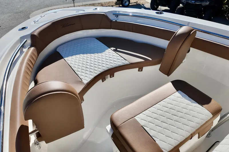 Slide: The Image of 2026 Pioneer 202 Sportfish boat interior with brown and white cushioned seating. - 13