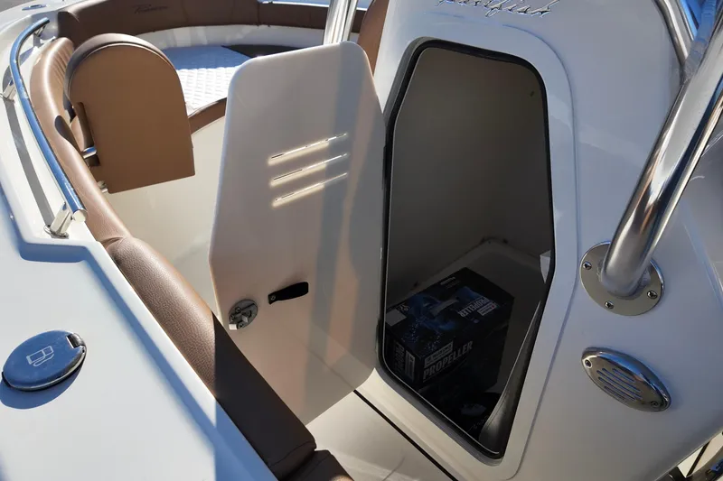 Slide: The Image of 2026 Pioneer 202 Sportfish boat interior with open storage compartment. - 6