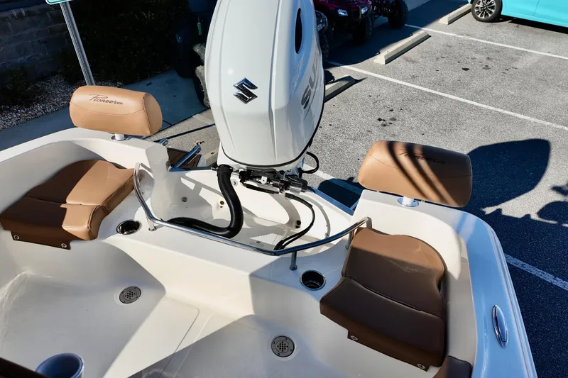 Slide: The Image of 2026 Pioneer 202 Sportfish boat interior with Suzuki engine and tan seating. - 9