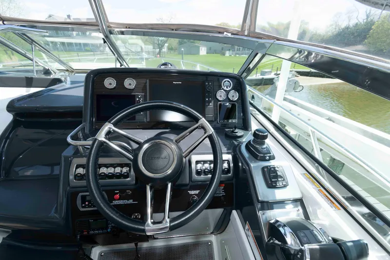 Slide: The Image of Cockpit of 2019 Formula 34 Performance Cruiser with steering wheel and control panel. - 10