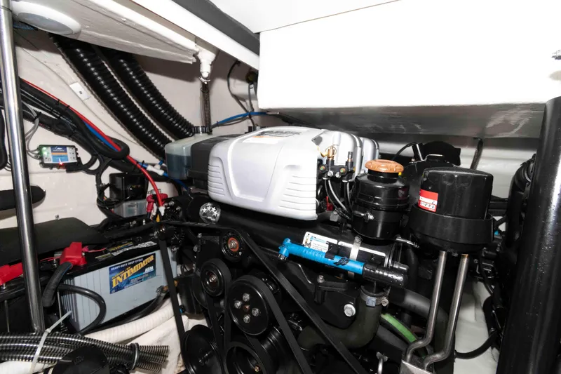 Slide: The Image of Engine compartment of a 2019 Formula 34 Performance Cruiser, showcasing mechanical components and wiring. - 25