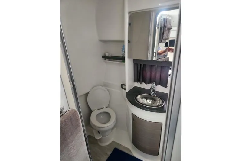 Slide: The Image of 2019 Formula 34 Performance Cruiser bathroom with toilet, sink, and mirror. - 7