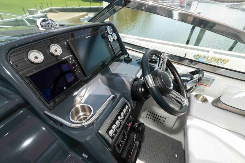 Slide: The Image of Helm of 2019 Formula 34 Performance Cruiser with modern controls and navigation displays. - 9