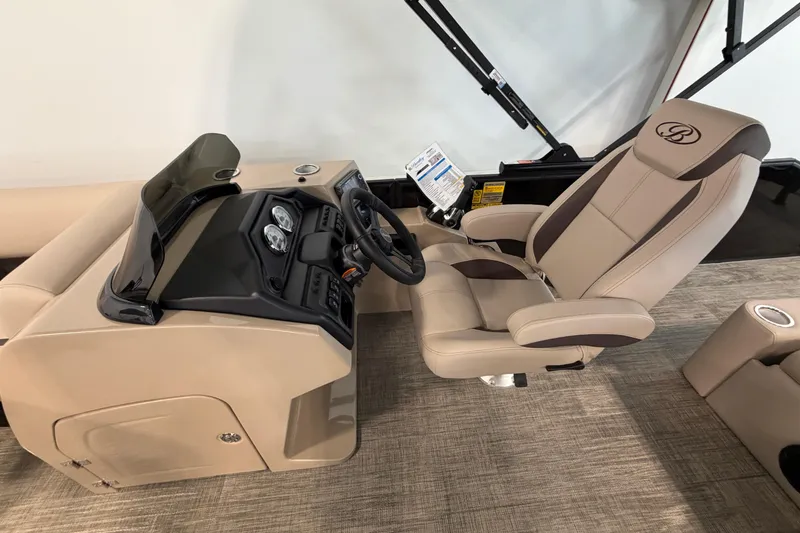 Slide: The Image of 2026 Bentley Pontoons Legacy 223 Swingback helm with beige captain's chair and dashboard. - 10