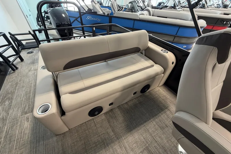 Slide: The Image of 2026 Bentley Pontoons Legacy 223 Swingback interior with beige seating and cup holders. - 9