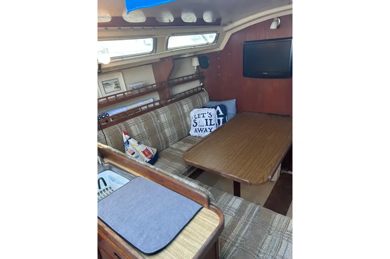 Slide: The Image of Interior of 1982 Catalina 30 sailboat with cozy seating and nautical decor. - 2