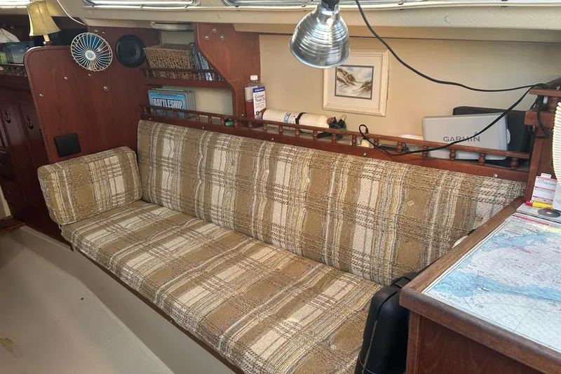 Slide: The Image of Interior of a 1982 Catalina 30 sailboat with plaid seating and nautical decor. - 3