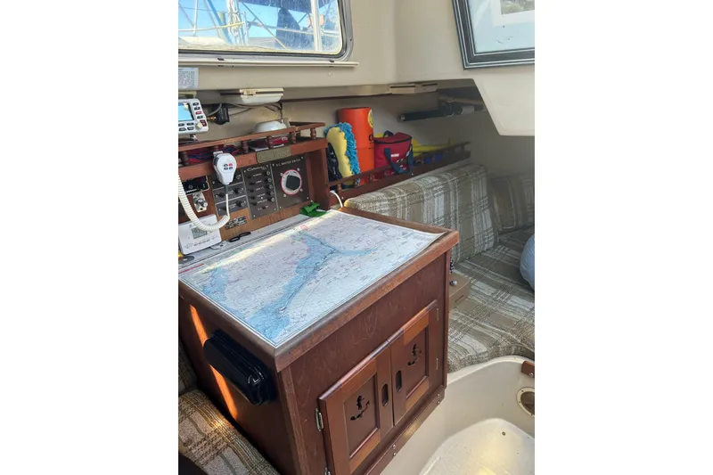 Slide: The Image of Interior of a 1982 Catalina 30 sailboat with navigation station and map. - 5