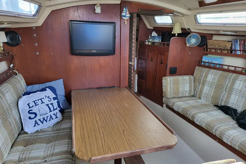 Slide: The Image of Interior of a 1982 Catalina 30 sailboat with cozy seating and nautical decor. - 6