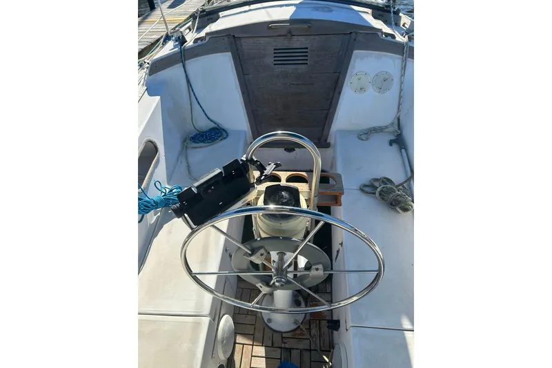 Slide: The Image of Cockpit of a 1982 Catalina 30 sailboat with steering wheel and ropes. - 9