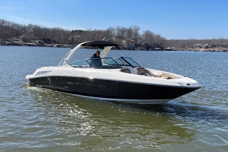 The Image of 2013 Sea Ray 300 SLX boat cruising on a calm lake under clear skies. - 1