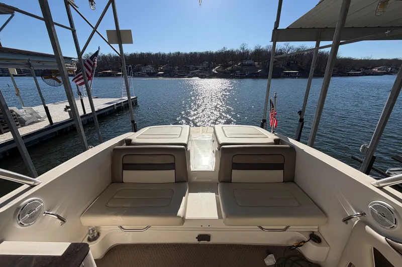Slide: The Image of 2013 Sea Ray 300 SLX boat interior with lake view and docked flags. - 14