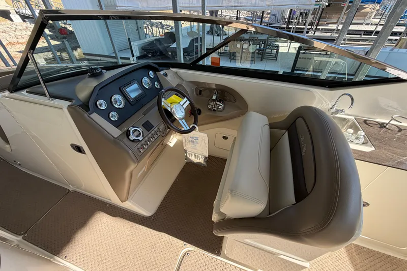 Slide: The Image of 2013 Sea Ray 300 SLX boat interior with steering wheel and dashboard controls. - 18