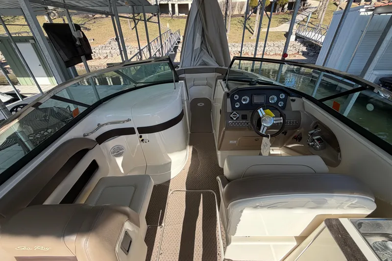 Slide: The Image of 2013 Sea Ray 300 SLX boat interior with steering wheel and seating area. - 20