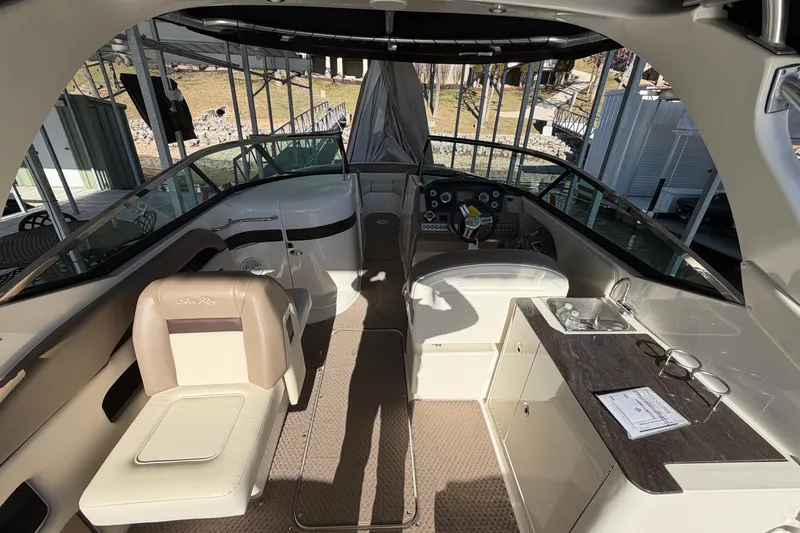 Slide: The Image of Interior of a 2013 Sea Ray 300 SLX boat with seating and helm. - 21