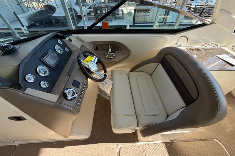 Slide: The Image of 2013 Sea Ray 300 SLX cockpit with steering wheel and control panel. - 23