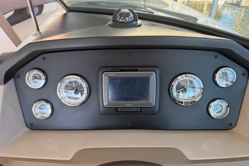 Slide: The Image of Dashboard of a 2013 Sea Ray 300 SLX boat with gauges and Garmin GPS. - 25