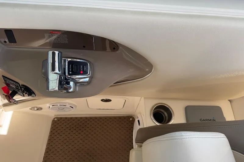 Slide: The Image of 2013 Sea Ray 300 SLX boat interior with control panel and Garmin device. - 29