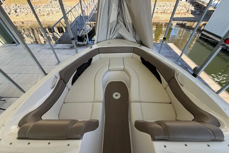 Slide: The Image of 2013 Sea Ray 300 SLX boat interior with cushioned seating and dock view. - 30