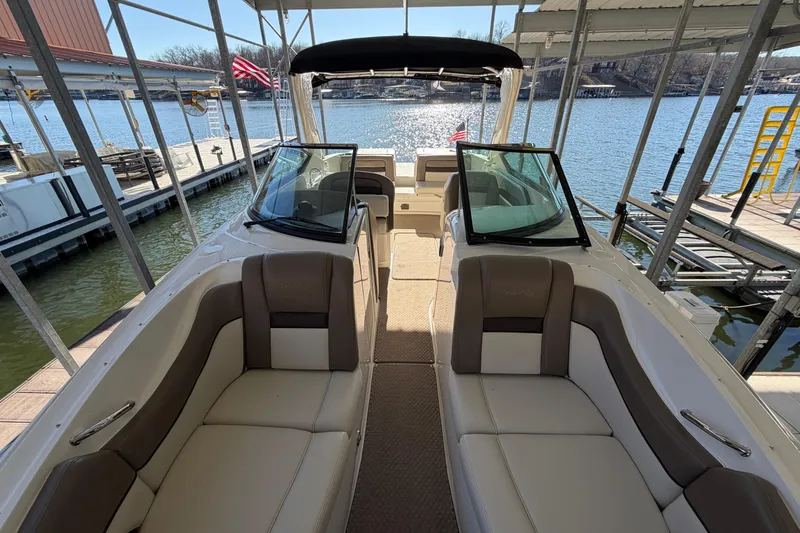 Slide: The Image of Interior view of a 2013 Sea Ray 300 SLX boat docked by the water. - 31