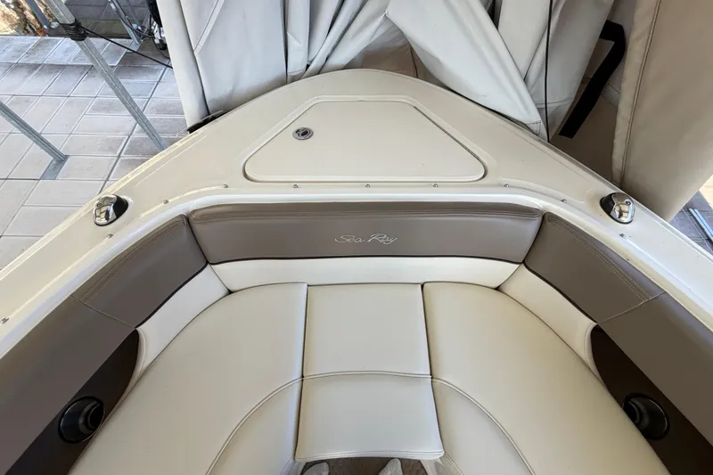 Slide: The Image of 2013 Sea Ray 300 SLX boat interior with beige seating and logo. - 34