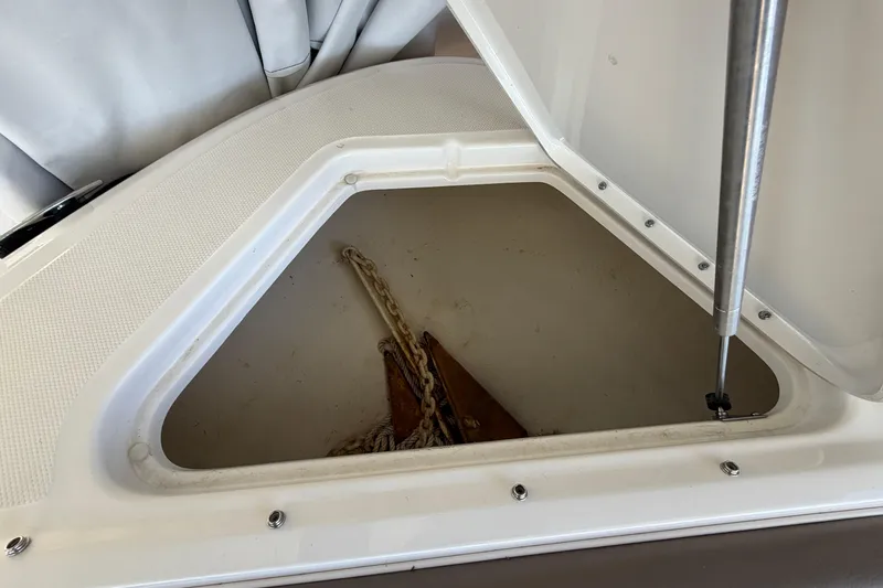 Slide: The Image of Open storage compartment on 2013 Sea Ray 300 SLX boat, showing anchor and chain. - 35