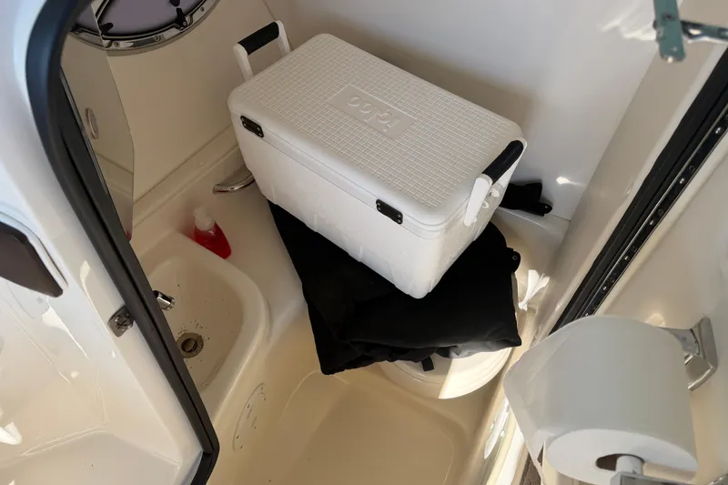 Slide: The Image of 2013 Sea Ray 300 SLX boat interior with cooler, sink, and toilet paper. - 39
