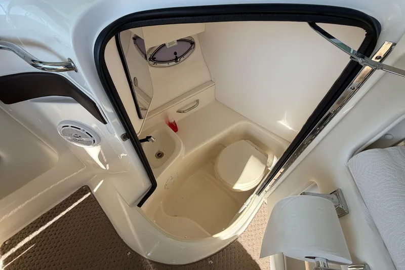 Slide: The Image of 2013 Sea Ray 300 SLX boat interior with compact bathroom and toilet. - 40