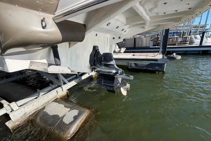 Slide: The Image of 2013 Sea Ray 300 SLX boat on lift, showing propeller and stern in marina. - 42
