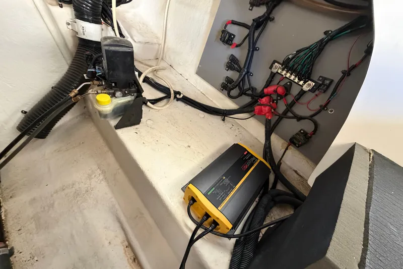 Slide: The Image of 2013 Sea Ray 300 SLX engine compartment with wiring and battery charger. - 45