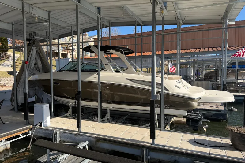 Slide: The Image of 2013 Sea Ray 300 SLX boat docked in a covered marina. - 5