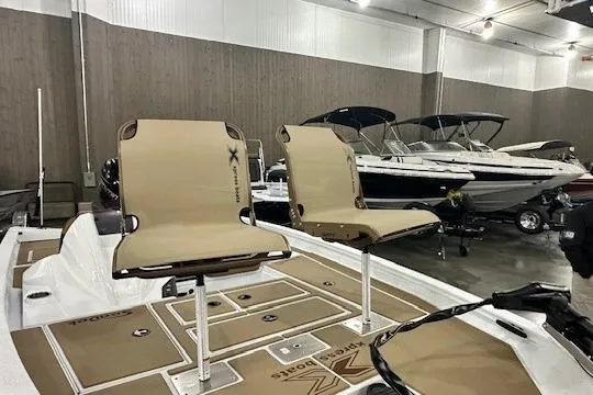 Slide: The Image of 2026 Xpress H18C Crappie boat with dual seats in showroom setting. - 2