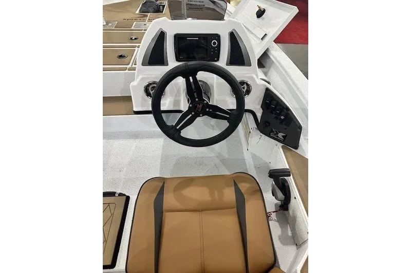 Slide: The Image of 2026 Xpress H18C Crappie boat interior with steering wheel and control panel. - 3