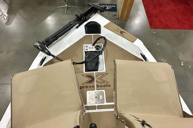 Slide: The Image of 2026 Xpress H18C Crappie boat interior with tan seating and fishing equipment. - 6