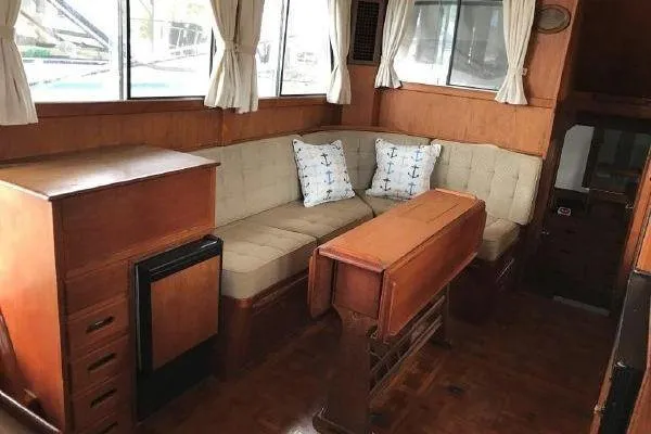 Slide: The Image of 1983 Grand Banks 36 Classic yacht interior with wood paneling and beige seating. - 10
