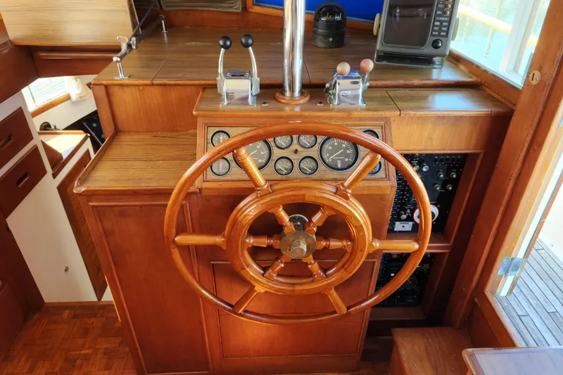 Slide: The Image of Helm of 1983 Grand Banks 36 Classic with wooden wheel and control panel. - 13