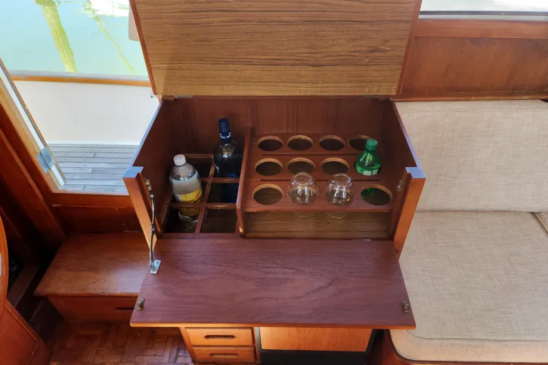 Slide: The Image of Bar cabinet on 1983 Grand Banks 36 Classic yacht with bottles and glasses. - 15