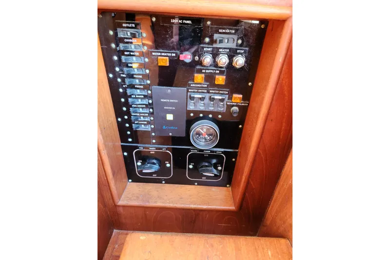 Slide: The Image of Control panel of a 1983 Grand Banks 36 Classic boat, featuring switches and gauges. - 21