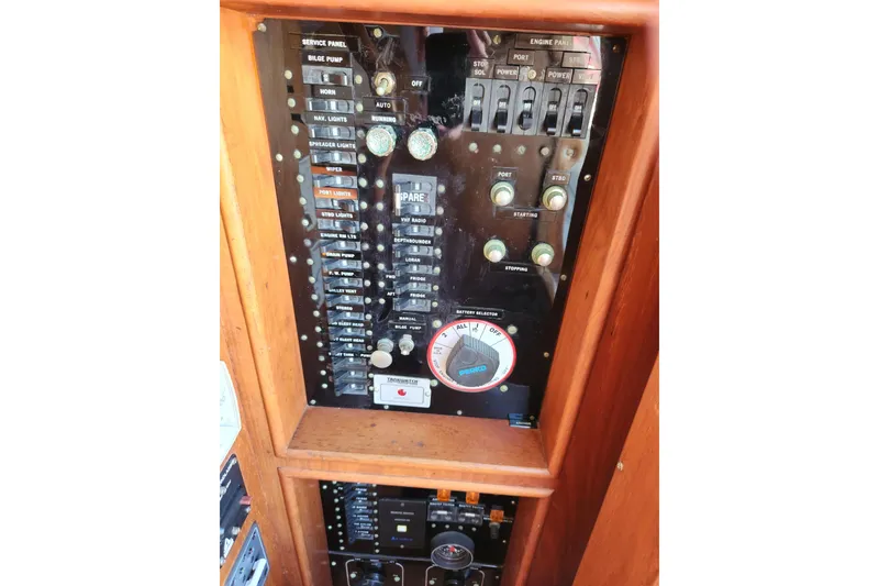 Slide: The Image of Control panel of a 1983 Grand Banks 36 Classic boat with various switches and dials. - 22