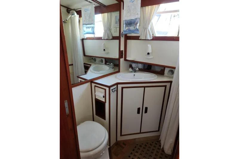 Slide: The Image of 1983 Grand Banks 36 Classic yacht bathroom with sink, mirror, and shower. - 29