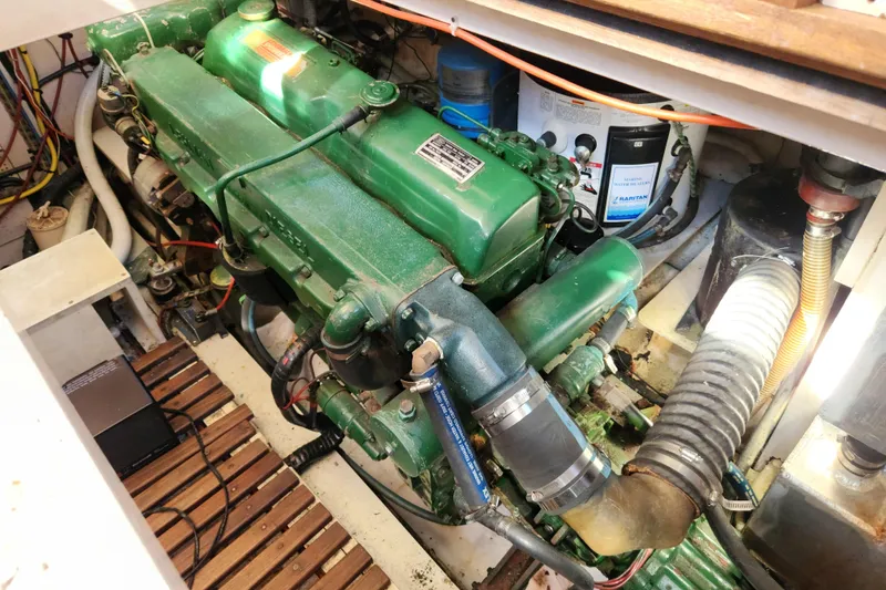 Slide: The Image of Engine room of a 1983 Grand Banks 36 Classic boat, showcasing a green marine engine. - 31