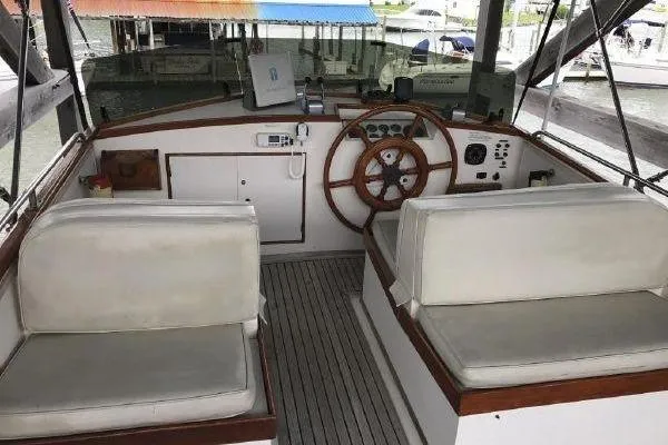 Slide: The Image of Cockpit of 1983 Grand Banks 36 Classic with wooden steering wheel and cushioned seats. - 34