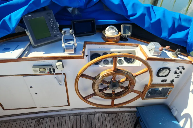 Slide: The Image of Helm of 1983 Grand Banks 36 Classic with wooden wheel and navigation instruments. - 35