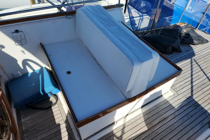 Slide: The Image of 1983 Grand Banks 36 Classic boat deck with white seating and wooden trim. - 37
